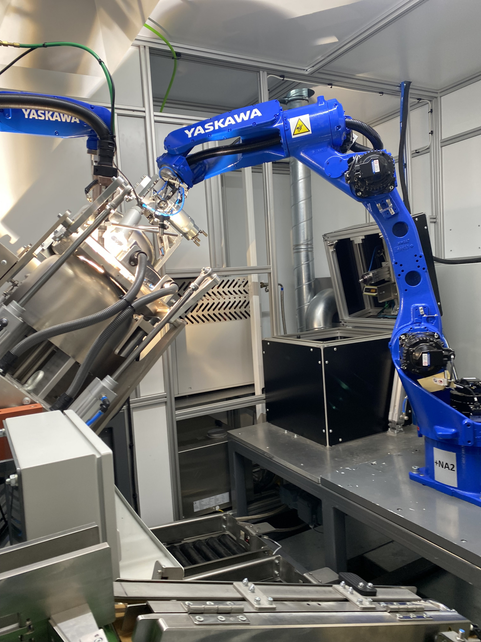 The two Motoman industrial robots literally work 